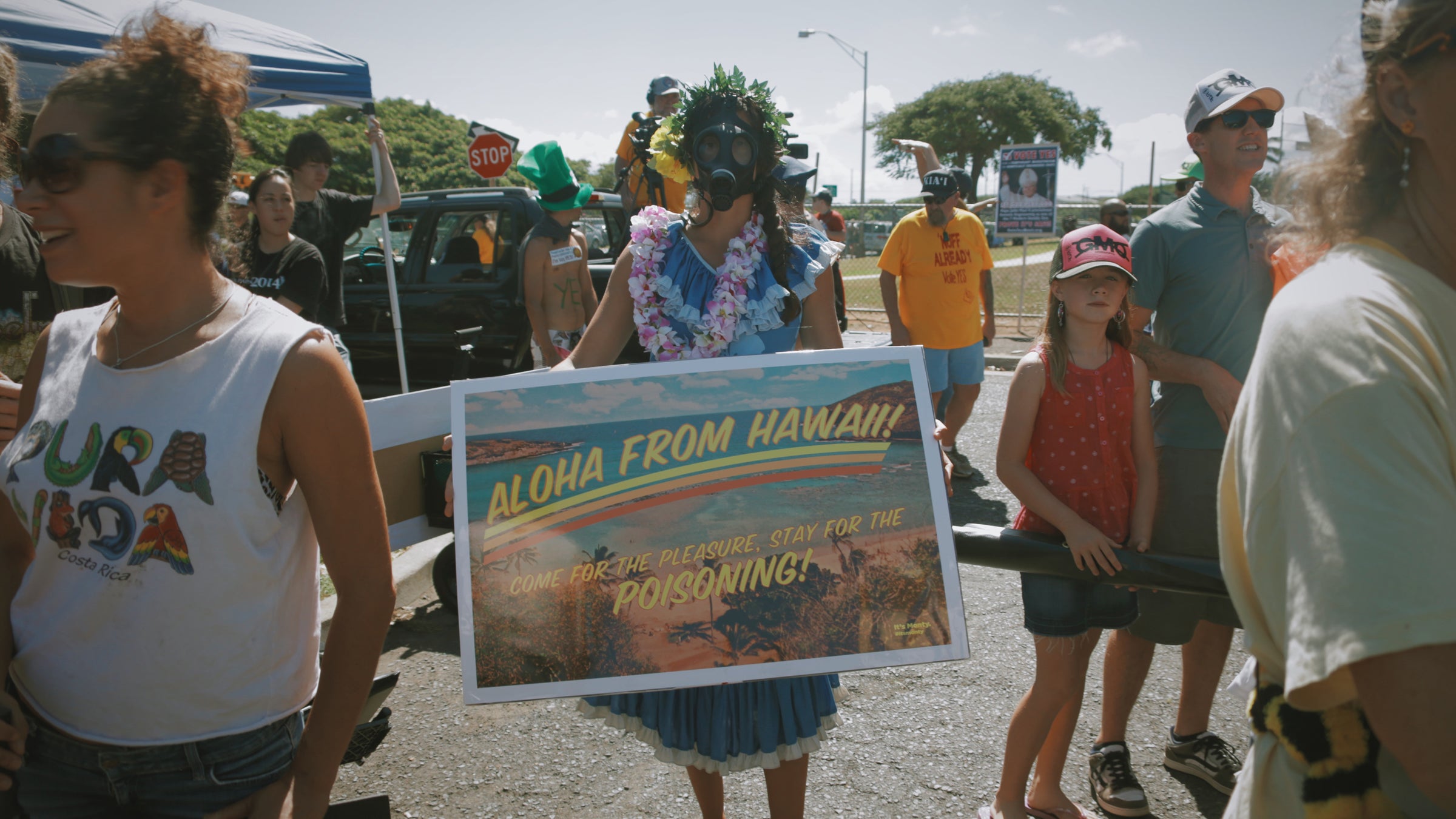A young woman protests GMO seed testing in Maui, where a similar debate about GM crops is taking place as the one in Kauai.