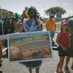 A postcard from paradise. A young woman protesting GMO seed testing on the island of Maui.