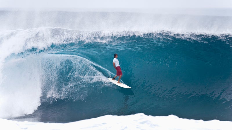 Randal Paulson surfing the barrel of Pipeline.