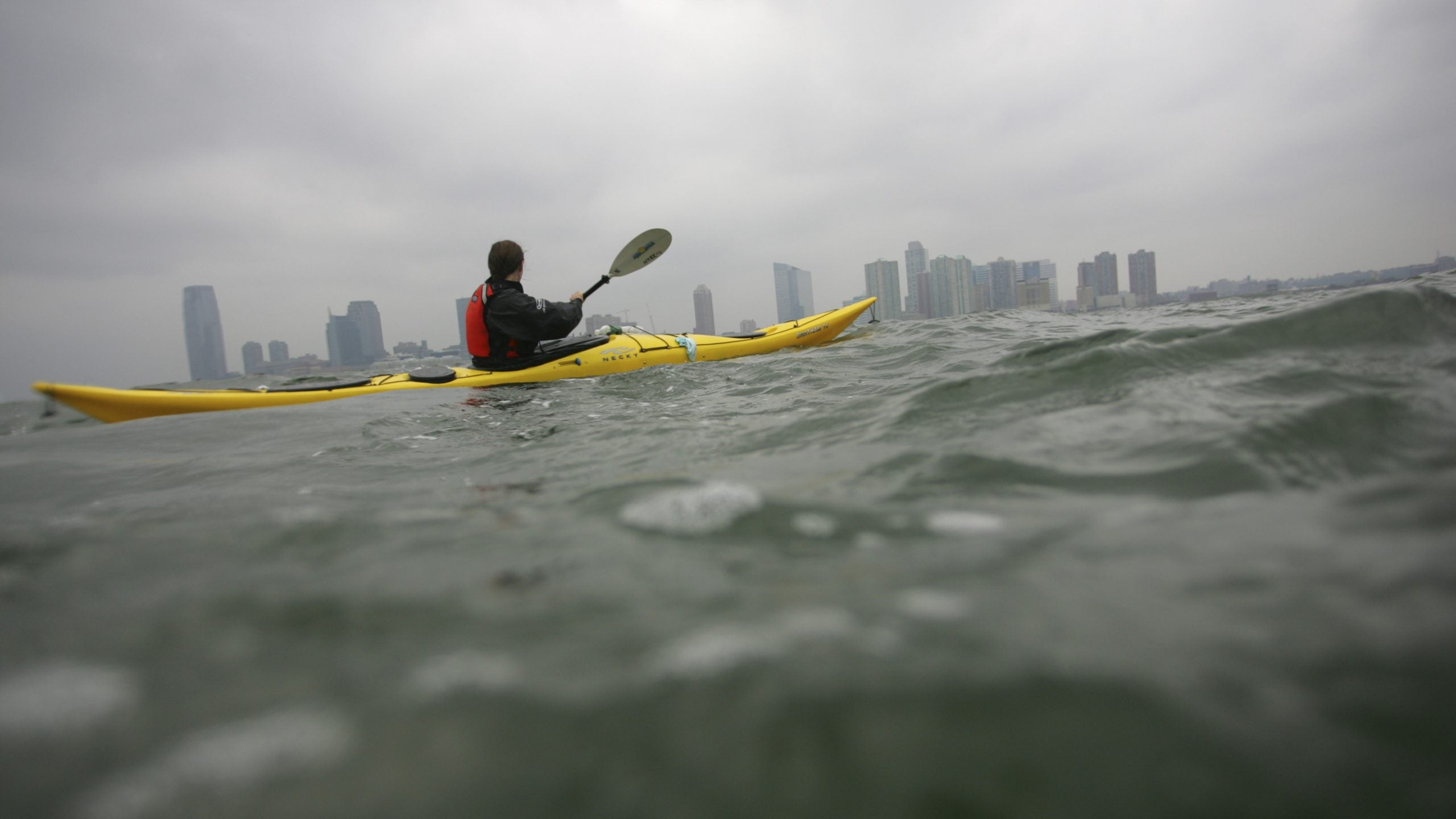 A sea kayaker paddles along the Hudson River.