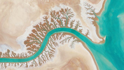 In 2013, author Benjamin Grant started running the DailyOverview Instagram account, which now has more than 500,000 followers. In partnership with DigitalGlobe, a Colorado-based satellite imaging company that supplies content for the likes of Google and Facebook, Grant began compiling and often stitching multiple images together to provide these new and always stunning perspectives of earth from above. Some views are of natural expanses without a human in sight; others are of the symmetry and crowding of an urban area. All of them have a way of making you feel small. Now, Grant has released a book, Overview, of these high definition satellite photographs with scenes ranging from Qinhuangdao Coal Terminal in China to the Rio Madre in the rainforests of Peru. Here, a preview of the nearly 300-page, hardcover beauty. Photo:Dendritic drainage systems are seen around the Shadegan Lagoon by Musa Bay in Iran. The word ‘dendritic’ refers to the pools’ resemblance to the branches of a tree, and this pattern develops when streams move across relatively flat and uniform rocks, or over a surface that resists erosion. Reprinted with permission from Overview by Benjamin Grant, copyright (c) 2016. Published by Amphoto Books, a division of Penguin Random House, Inc. Images (c) 2016 by DigitalGlobe, Inc.