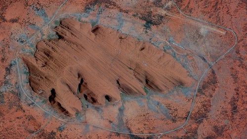 Uluru, or Ayers Rock, is a large sandstone formation in the Northern Territory of Australia. The monolith鈥攖owering 1,141 feet high and around 2.2 miles wide鈥攊s a sacred site to the Aboriginal people of the area who first settled there 10,000 years ago. While the first Australian tourists arrived at Uluru in 1936, annual visitor numbers rose to over 400,000 by the year 2000. Increased tourism at the site provides regional and national economic benefits, but also creates an ongoing challenge to balance conservation, cultural values, and visitor needs.