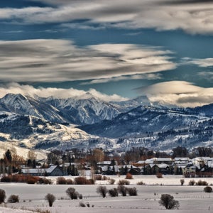 Houses dot the horizon, beneath snow-covered mountains in Jackson Hole, Wyoming.