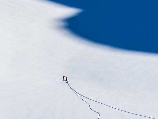 Last spring, after traveling 30 hours from Whistler, British Columbia, Andrew Strain landed in Akureyri, in northern Iceland, and immediately boarded a helicopter bound for the mountains of the Hidden Land Peninsula. Strain was exhausted, but when you get a chance to heli-ski in Iceland with Olympic snowboarders, “you do what you can to stay awake,” says the 32-year-old photographer. Strain watched Scotty Lago and Greg Bretz shred a line down a long ridge, and when they stopped to wait for the helicopter near the shadow of the peak they’d just descended, he knew he had a good shot. “I didn’t direct them, they just ended up there,” he says. “It’s such a simple composition.”

The Tools: Nikon D810, 70–200mm f/4 lens, ISO 200, f/8, 1/1,000 second