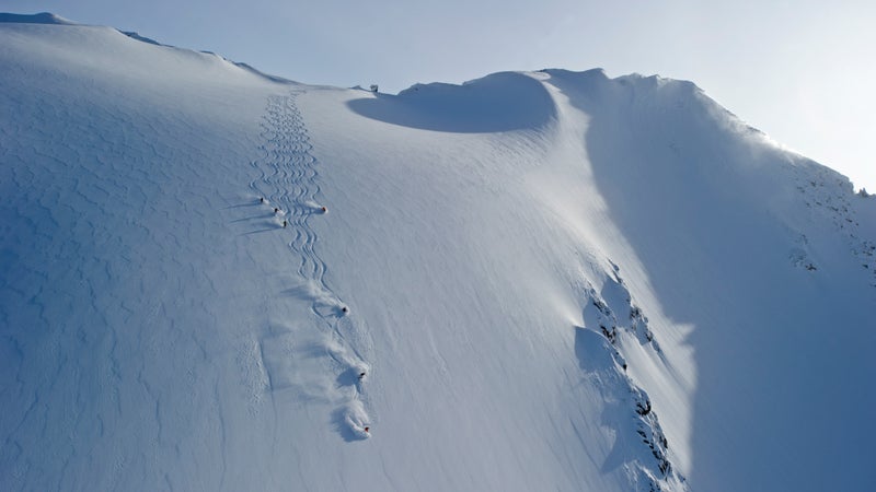 A group of heliskiers at CMH Cariboos snake their way down a drool-worthy open powder slope.