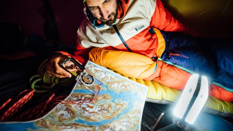 Andrew pores over a topo map in search of new climbing objectives.