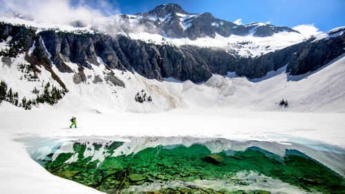 Many of these glaciers have never seen a skier, let alone humans. I love the ability to explore and see these incredible places. Here, Adam Roberts crosses Blum Lake on the Makin’ Bacon Traverse in North Cascades National Park.
Sadly, Roberts, seen in many of these images, died in an avalanche at White Pass Ski Area in Naches, Washington, on December 27, 2016. Losing friends to the mountains is humbling. Nature is a great equalizer in that regard. It can bite any of us. But Adam was most at peace when in nature. He was quite literally a guy who would sit in a meadow and smell the flowers. It’s a rare soul these days who can turn off the noise and turn on the current moment. You can read more about his life here.
You can follow Jason Hummel’s adventures in the mountains on Instagram or Facebook.