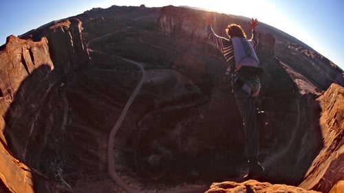 Dean Potter base jumping off the Tombstone cliff outside of Moab, Utah.
