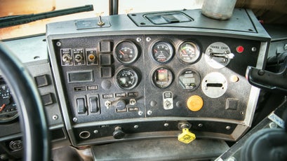 The dashboard of a Mack snowplow truck—though stuffed into a small cabin, is packed with gauges and switches for everything from surface temperature monitoring and air filter restriction to manual transfer case lockup.