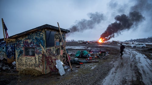 Campers set fire to structures in preparation for the 2pm deadline to vacacte the Ocetisakowin Camp in North Dakota.