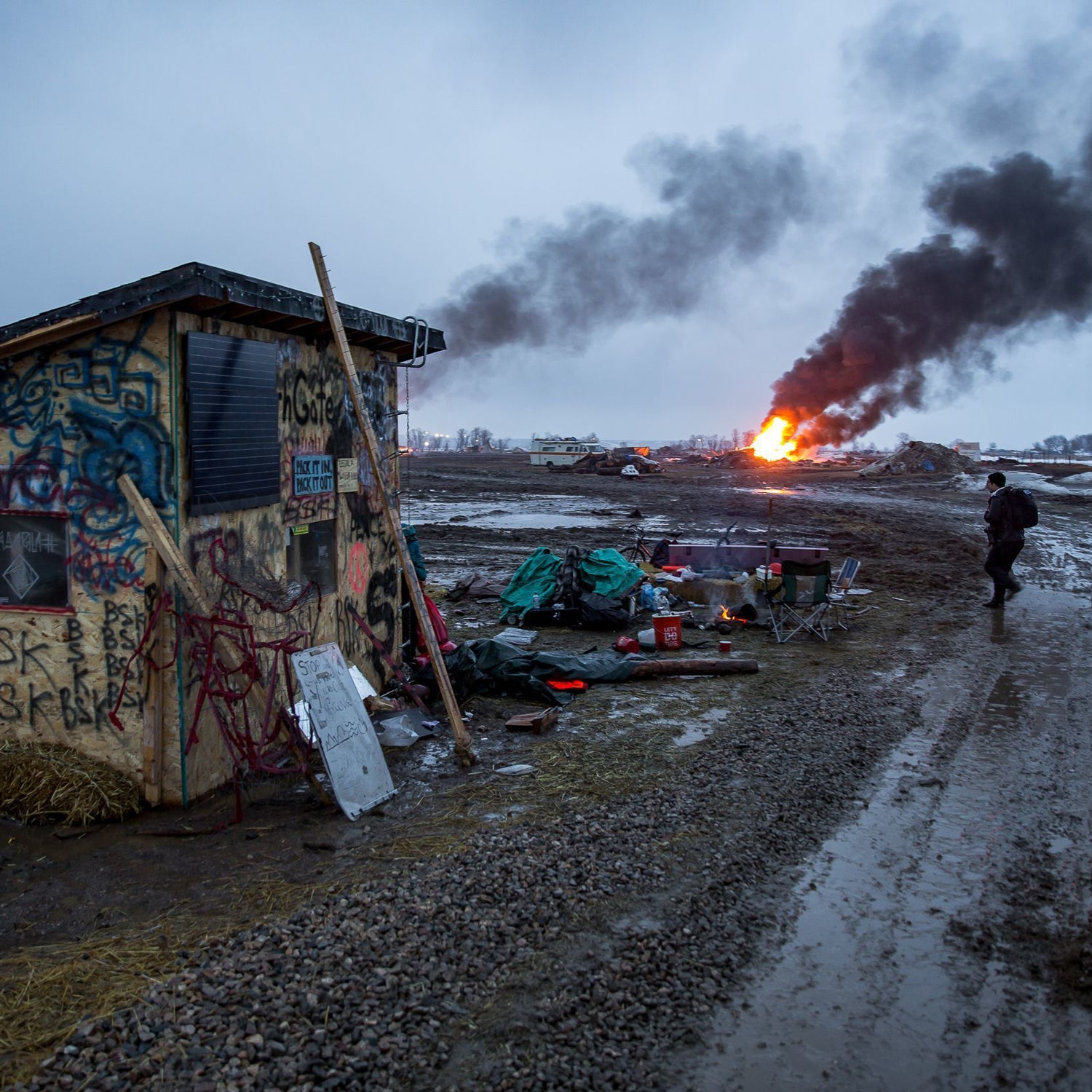 Campers set fire to structures in preparation for the 2pm deadline to vacacte the Ocetisakowin Camp in North Dakota.