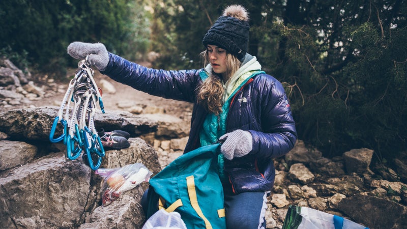 Hayes unpacks her bag for a day of climbing. The bag she is unpacking is actually her mother's bag, which Cathy Hayes used to travel the world when she was young.