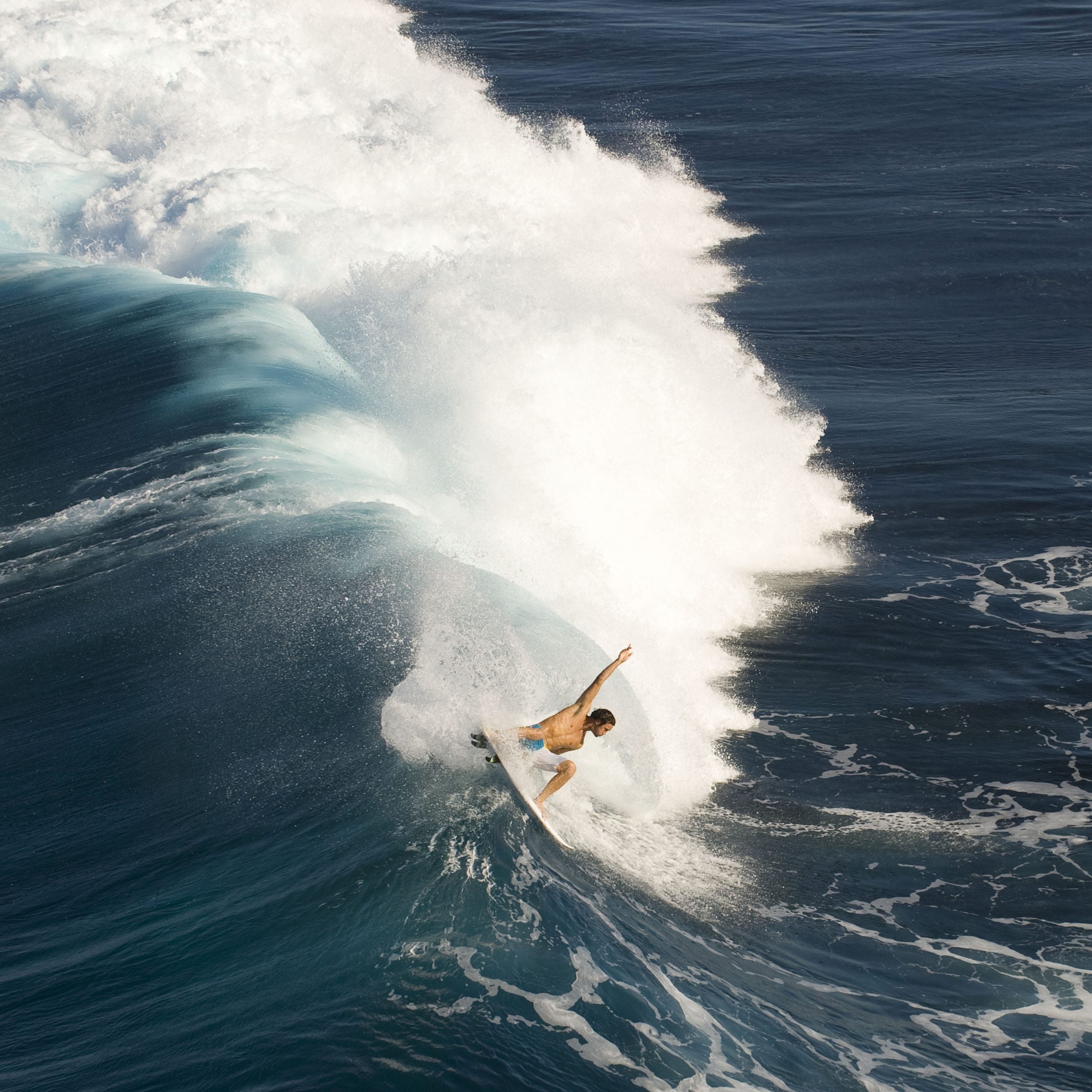 Surfer catches a wave in St Pierre, Reunion Island, France.