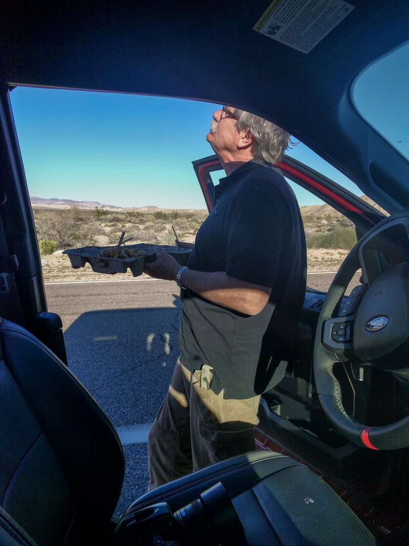 Our apple pie from Mom's in Julian flew out of the bed and splattered on the road. Pelton scraped it up, offered me a bite, and then proceeded to wolf the entire thing down roadside. Here, he's looking up at a specially modified Navy SEAL helicopter circling overhead. I think they wanted a good view of our truck.