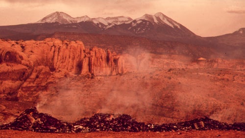 With the Environmental Protection Agency currently under attack, it’s a good time to reflect on what big swaths of this country looked like before Richard Nixon created the organization in 1970. Almost 50 years ago, the Republican former president commissioned a photography project called Documerica to illustrate miles and miles of environmental degradation, advocating for the need for the agency. The following are some of the most striking images from that project.
Photo: In the 1970s, the Moab City Dump created haze and smoke visible in the nearby town. The La Sal Mountains are seen behind the burning rubble.