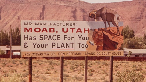A sign advertises Moab as a destination for industry, not tourism, in 1972.