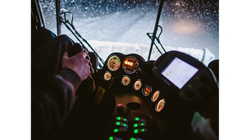 The cat鈥檚 cockpit has room for two, plus a sound system and heaters that blast hot air. Two levers on the left control the speed of each track, and a joystick on the right controls the plow and groomer blades. Most of the guys arrive with experience working construction rigs or tractors.