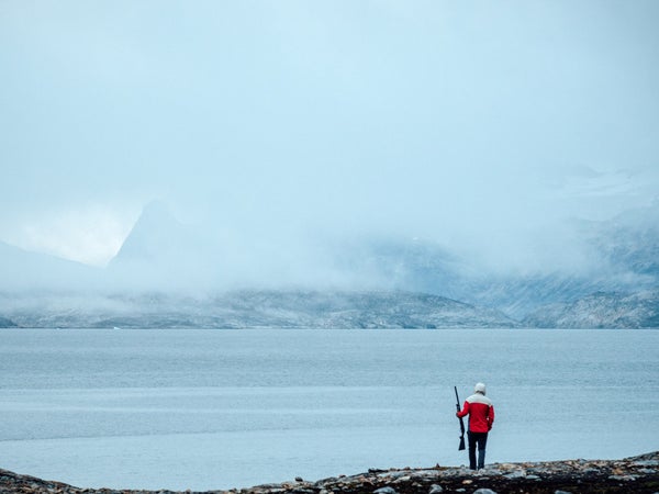 Andrew Yasso on polar bear patrol outside camp at night in eastern Greenland.