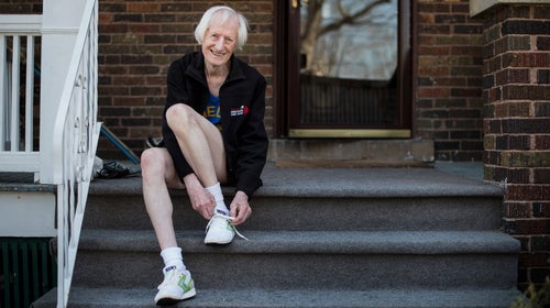 Ed tying his faithful old pair of Brooks shoes for a run.