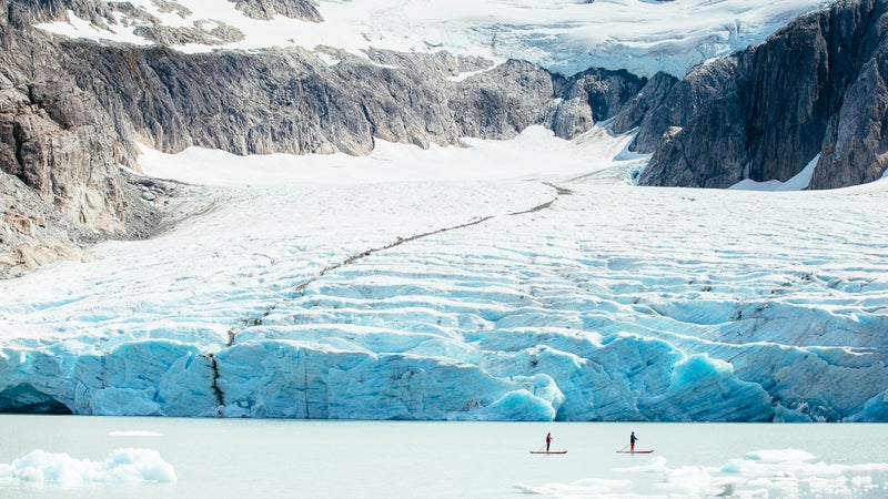 Stand up paddleboarding past a glacier in Nimmo Bay, BC.