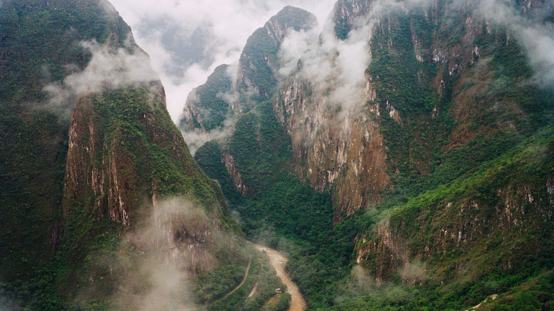 A view of foggy mountains in Machu Picchu.