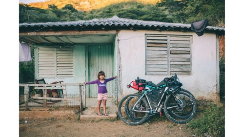 On day one of the expedition, we pedaled about 40 miles from Santiago de Cuba into the Sierra Maestra. After a long and tedious dirt-road climb, we were invited to camp on a flat spot at this finca, or small working farm. The next morning, Natalia was waiting for us to emerge from our tents.
