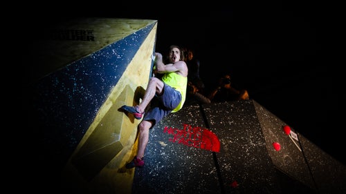 After wrestling with this problem for nearly the duration of his four-minute allowance, Daniel Woods finally makes it to the top of this volume-only route. Here, he lets out a whoop after reaching the top.