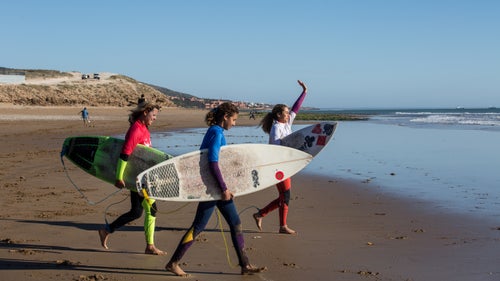 鈥淚鈥檝e been competing for years, and now this is the first time my daughters have competed with me,鈥 says Berrada, who picked up surfing while pregnant with her second daughter, Kenza Guemmi. 鈥淪ince I had my daughters, I鈥檝e dreamed of them competing with me. I hope they鈥檙e going to continue and that this will motivate them.鈥
Above, from left: Berrada, Lilias Tebbai, and Berrada鈥檚 older daughter, Ghita Gemnmi, 16, head out to compete in the semifinals.