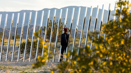 A visitor looks at Phillip K. Smith III's installation, 