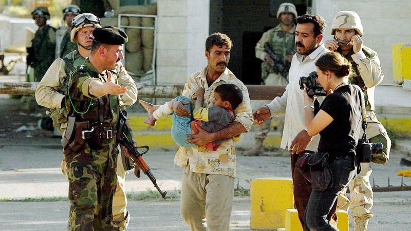 Addario photographing an Iraqi man in Kirkuk as he is denied entry to an American-run hospital after the boy sustained a bullet injury.