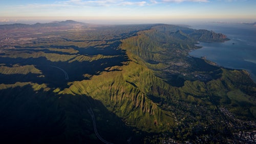 Early morning light fills the cracks of the Ko鈥檕lau Mountain Range. The conspicuous linear crest is the western rim of the extinct Ko鈥檕lau volcano and represents the route to traverse the entire range.