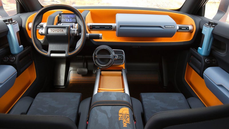 Here you can see the water bottle door handles, and sleeping bag arm rest. That big twist-handle on the radio is a tactile theme continued throughout the car, but if you twist this one, the rechargeable radio pulls out, so you can play music in camp.