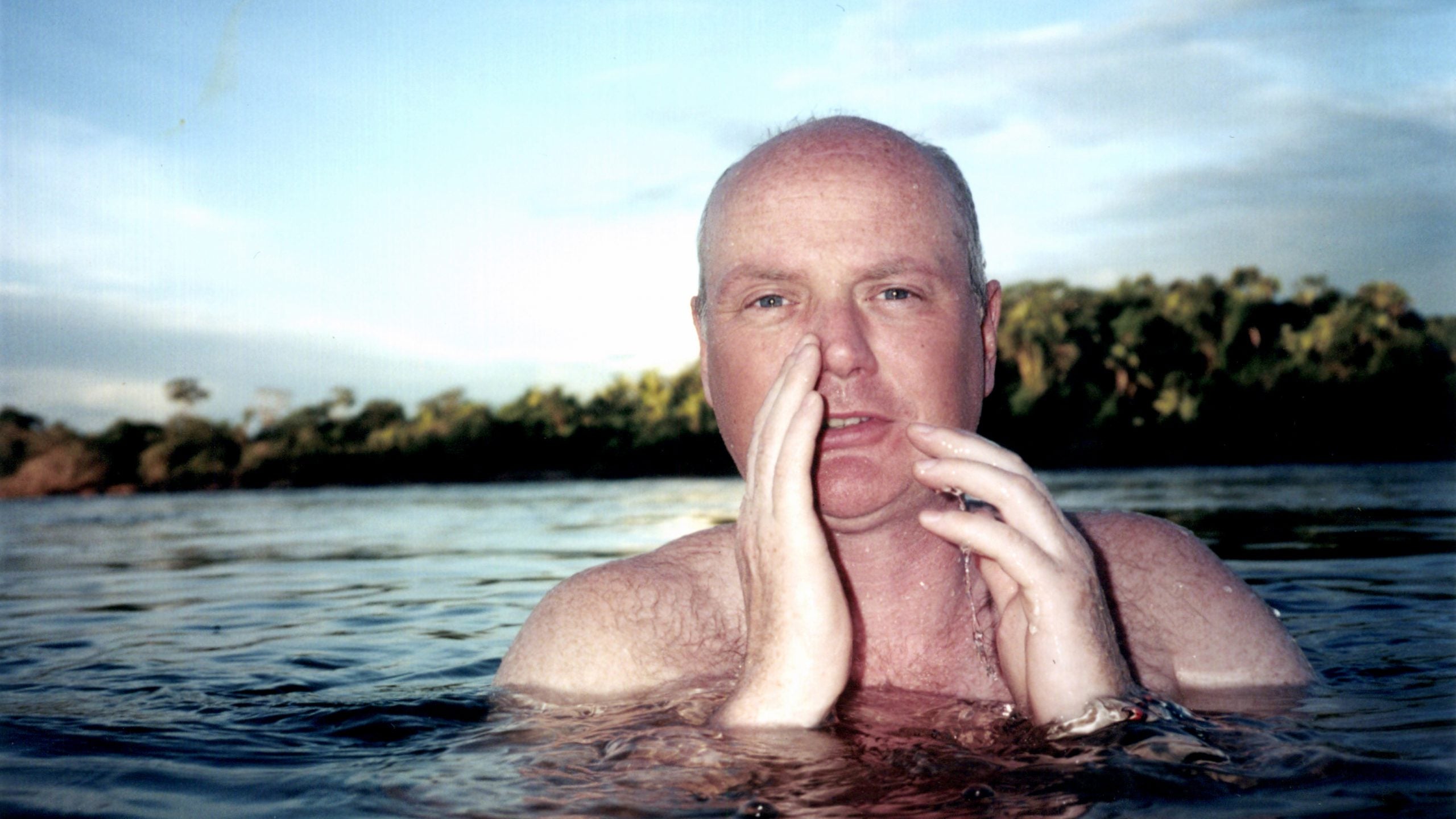 Patrick Symmes is notorious for traveling to conflict-prone areas around the globe. Here, he swims in Brazil's Xingu River.