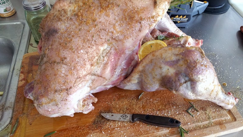 Before smoking the turkey, I stuff it with lemons, butter, rosemary, and sage. I carry that little ESEE Camp Lore CR2.5 as my field knife for processing fish and birds and use a WorkSharp Combo Knife Sharpener to keep an edge on it as I work in the kitchen.