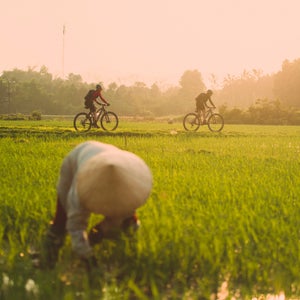 In 1972, the father of four-time world champion mountain biker Rebecca Rusch died when his plane was shot down over Laos during the Vietnam War. She was three years old at the time. More than 40 years later, Rusch decided to set out on the 1,200-mile Ho Chi Minh Trail in search of her father’s crash site. Accompanied by Vietnamese cycling champion Huyen Nguyen, a small support team, and a film crew from Red Bull Media House (they’ll release a film this summer), Rusch and Nguyen traveled through villages, jungle, and rugged terrain for just under a month in the spring of 2015. 
We caught up with Rusch, who lives in Idaho, to give us a preview of the upcoming film, Blood Road.
Photo: Rebecca Rusch and Huyen Nguyen pedal the Ho Chi Minh Trail through the rice fields of Vietnam. During the war, the trail acted as a pathway of support, materials, and military personnel, stretching from the northern part of the country through Laos, Cambodia, and into southern Vietnam. Rusch and Nguyen began their ride in Hanoi.