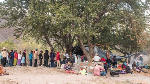 Each year, the Tarahumara emerge from the canyon system and are hosted by the city of Urique. The city builds temporary camps, gives them sleeping pads, and provides food for the crowd. The Tarahumara also receive corn vouchers for running the race. If they hit certain checkpoints along the course, they get wristbands that can later be redeemed for vouchers as well. According to Miller, many of the Tarahumara depend on these subsidies to feed their families—most of the Tarahumara are subsistence farmers who grow corn, fruit, potatoes, beans, and squash.