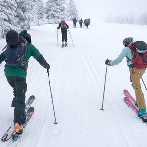 Outside staffers skinning up the local ski hill in Santa Fe before work on a powder day.
