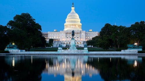 The Capitol Building and Reflecting Pool in Washington D.C. America, illuminated at night.