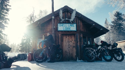 Along the trail, various shelters, cabins, and roadhouses offered an opportunity to get out of the cold, grab a bite to eat, and even a warm place to sleep. Here at Shell Lake Lodge, Frank Janssens unpacks gear he plans to dry inside in the early days of the race.