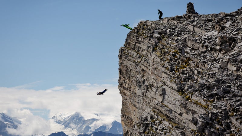 Kat Donahue, Scotty Bob Morgan, and Hartman Rector jump near Lauterbrunnen Valley.