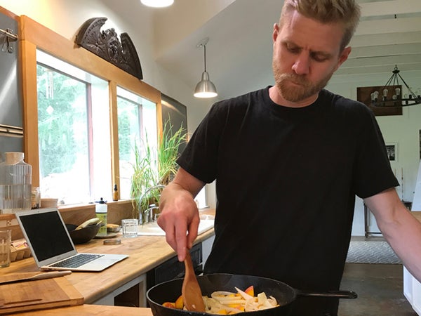 man cooking a meal on a stove