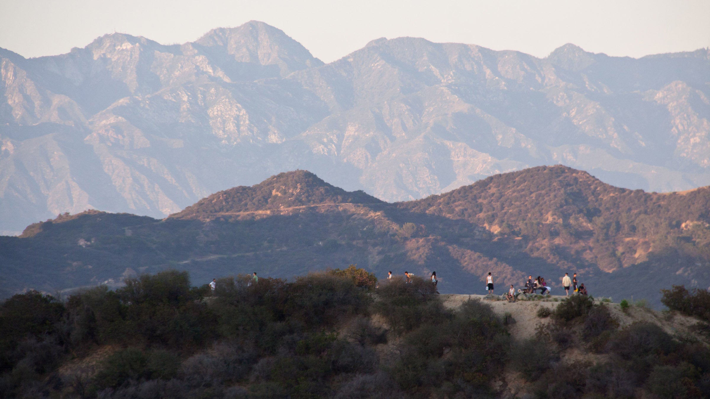 Hikers atop the eastern trail in Los Angeles' Runyon Canyon Park. Offering 160 acres of nature, and sweeping views of the city, ocean, and surrounding mountains, Runyon is located in central Hollywood.