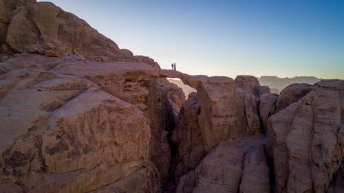 Hussein and Omer taking a moment on Burdah Arch, near Wadi Rum.