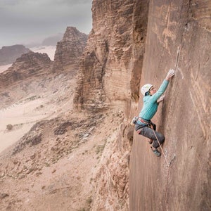 This January, in the heart of the Middle East, a crew of rock climbers set out to establish an 1,800-foot, 14-pitch, 5.13+ route up Jordan’s Jebel Rum. On the outskirts of Wadi Rum, a region in the southern part of the country, the team composed of Mohammad Hussein, Madaleine Sorkin, Elad Omar, and Eli Nissan linked up with the local Bedouin people who have been working hard to establish a market for adventure tourism. 
After three weeks of cleaning and searching for the best routes, the climbing team left without the opportunity or time for a free ascent. Just two weeks later, another team from the Czech Republic free-climbed the route in a continuous two-day effort with the blessing of the establishing crew. 
Colorado-based filmmaker Henna Taylor, who is making a movie about the route’s creation, shares her best shots from the initial trip. 
Photo: Boulder, Colorado–based pro climber Madaleine Sorkin attempts the fourth and most difficult pitch (5.13d) on the project we named the Sultan ul-Mujahidin, which translates to “Sultan of the Freedom Warriors.”