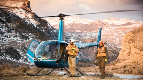 The southern Wind River Range provides a dramatic backdrop as Coates (left) and Colton Hodson (right) prepare for a long day in the chopper. Coates and Hodson have arguably the most dangerous and exciting job in wildlife biology.