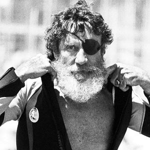 Jack O'Neill suits up in the small craft harbor before windsurfing off Santa Cruz, California, August 5, 1982.
