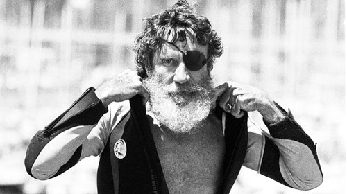 Jack O'Neill suits up in the small craft harbor before windsurfing off Santa Cruz, California, August 5, 1982.