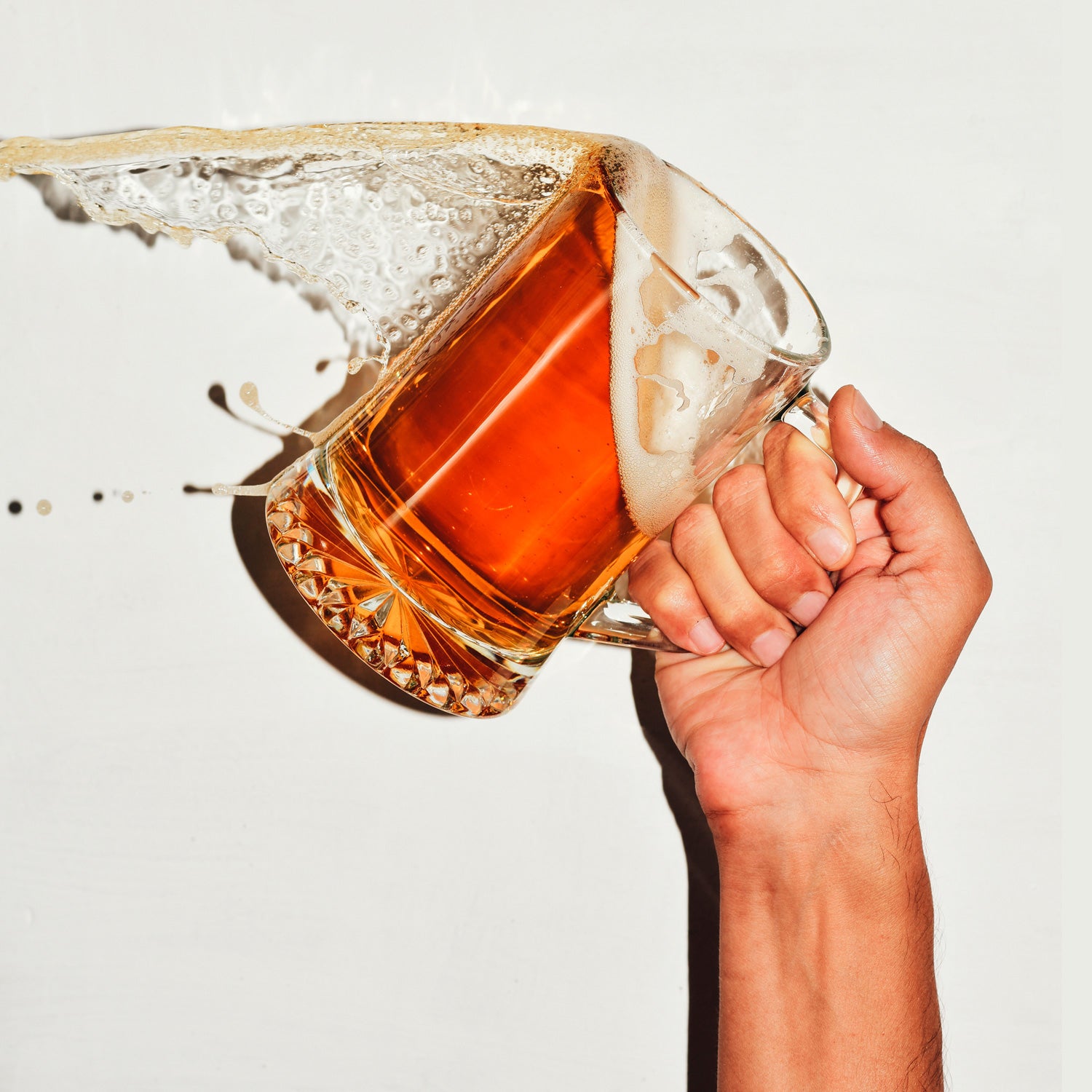 man spilling a jar of beer