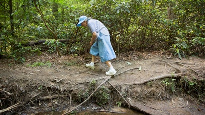 Phyllis Light, the oldest member of the group, scrambles up the bank of one of the many stream crossings.