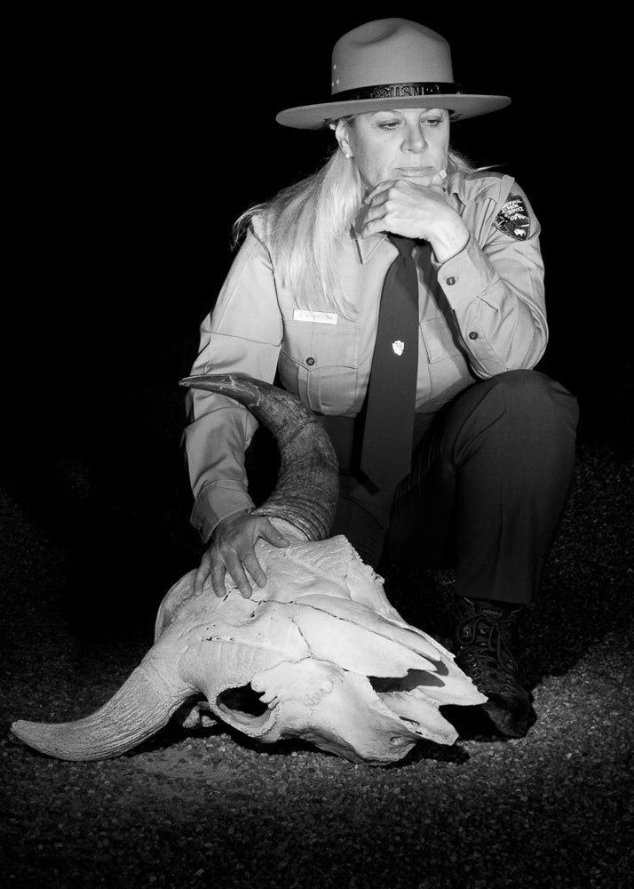 Beth contemplates the bison skull, which is used in ranger presentations and was moved for this portrait to Fountain Flats, Yellowstone National Park.
